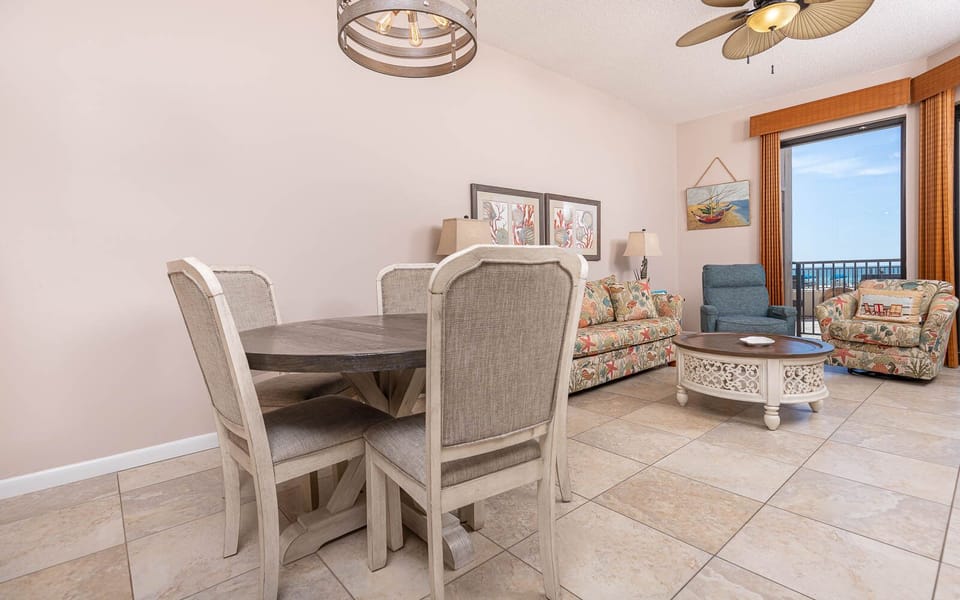 Gather around the round dining table while enjoying the colorful decor and comfortable seating in the inviting living area