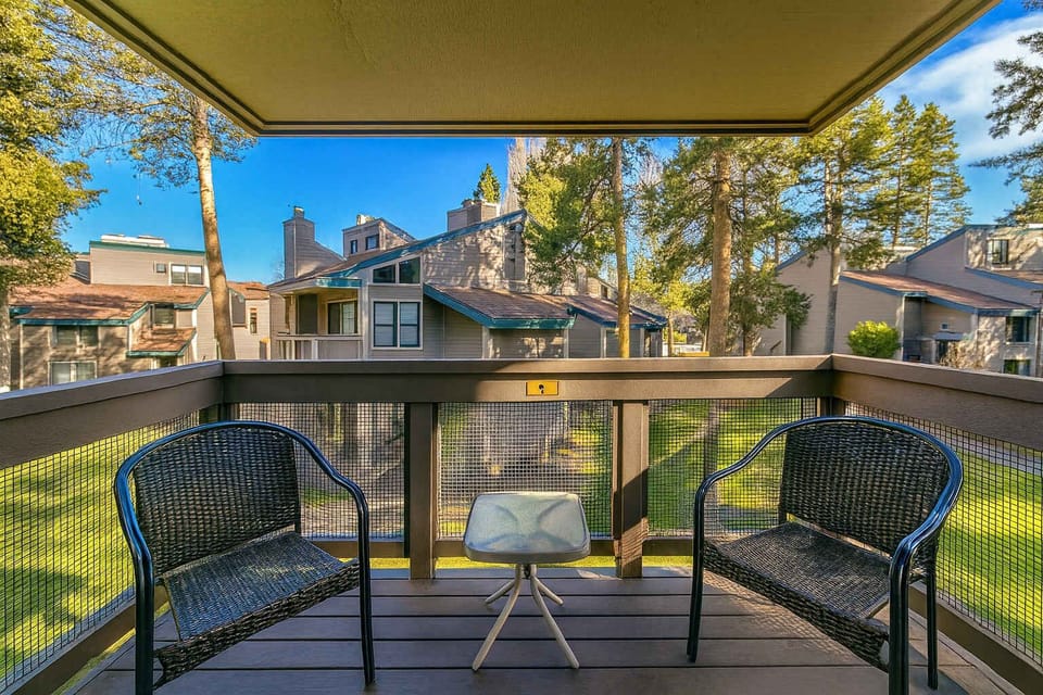 Relax on this cozy balcony surrounded by tall pines—your perfect spot for morning coffee, fresh air, and peaceful neighborhood views.
