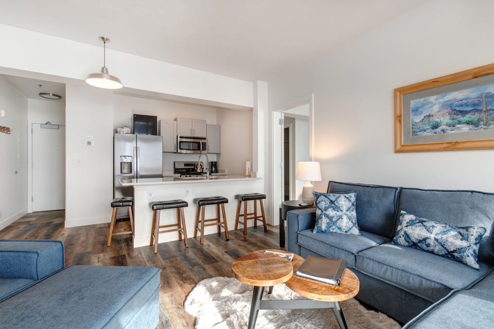 The Mason at Stillwater 3013: Cozy sofa set, and dining table, with a glimpse of the kitchen.