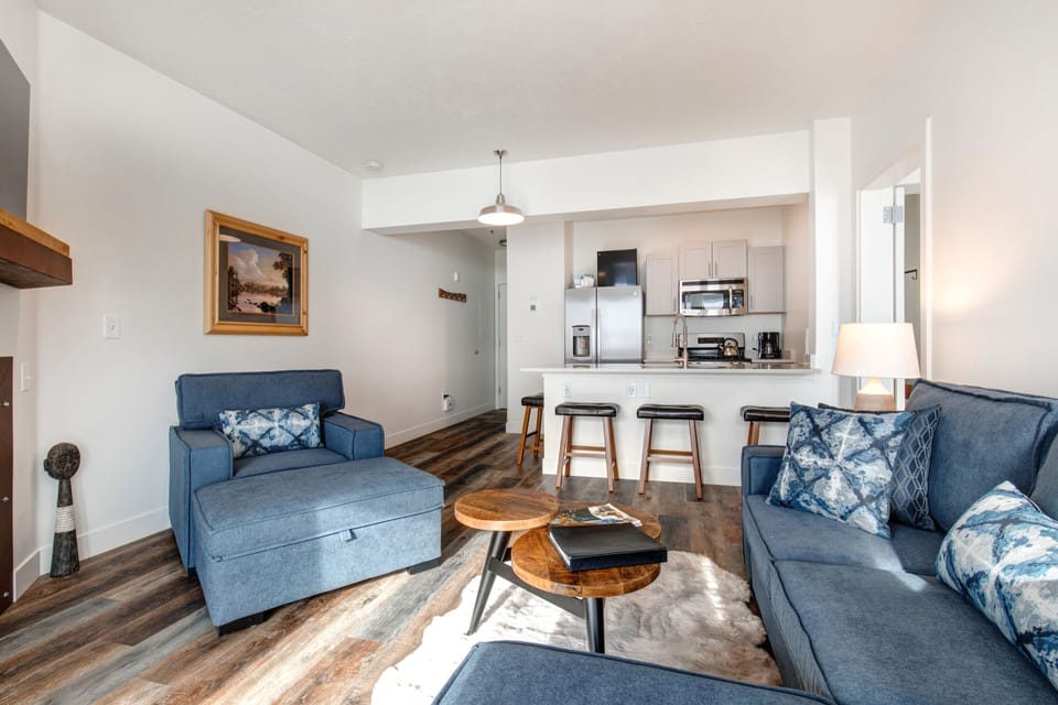 The Mason at Stillwater 3013:Cozy sofa set, and dining table, with a glimpse of the kitchen.