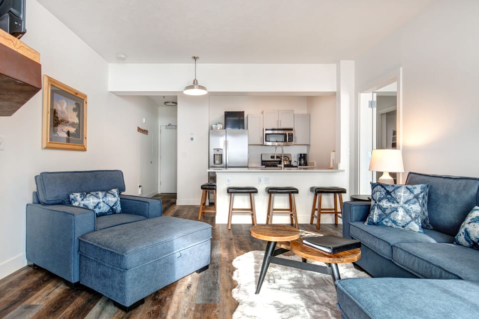 The Mason at Stillwater 3013:Cozy sofa set, and dining table, with a glimpse of the kitchen.