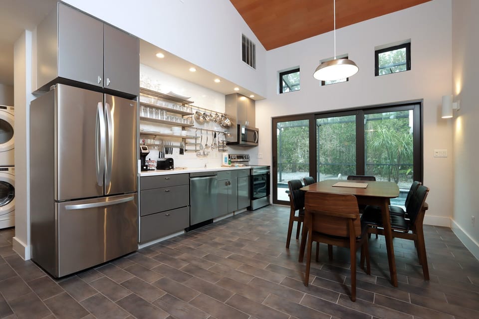 Kitchen with stainless steel appliances and dining table