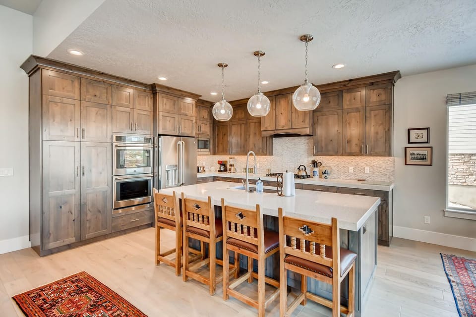 Jordanelle Estates 13299: Modern appliances and ample storage in sleek kitchen design.