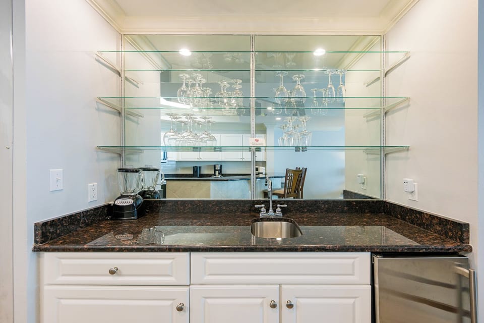 Mix refreshing cocktails at the sleek wet bar, creating moments of joy as you unwind with family