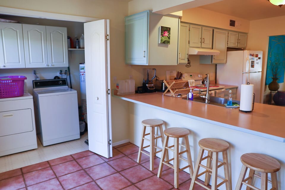 Full Size Washer/Dryer Near Kitchen and Bar Area