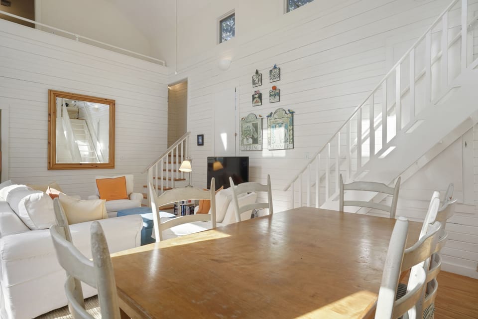 DINING VIEW TO LIVING AND BONUS LOFT STAIRCASE