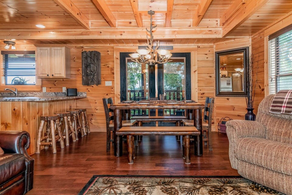 Custom log dining table offers seating for 6 with seating for 4 at kitchen counter