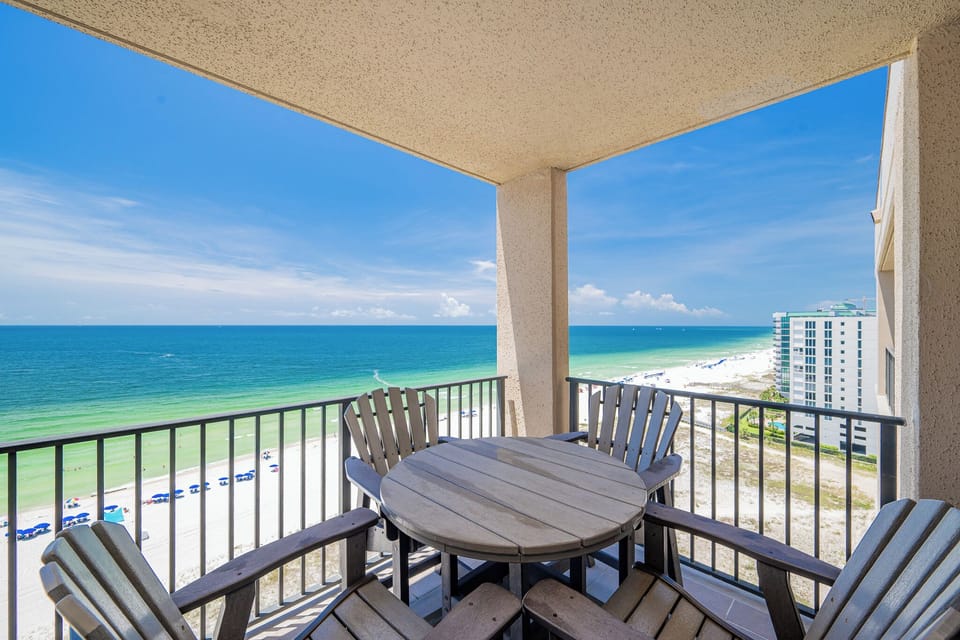 Enjoy meals or drinks at the patio table while taking in the beautiful views of the water and beach below