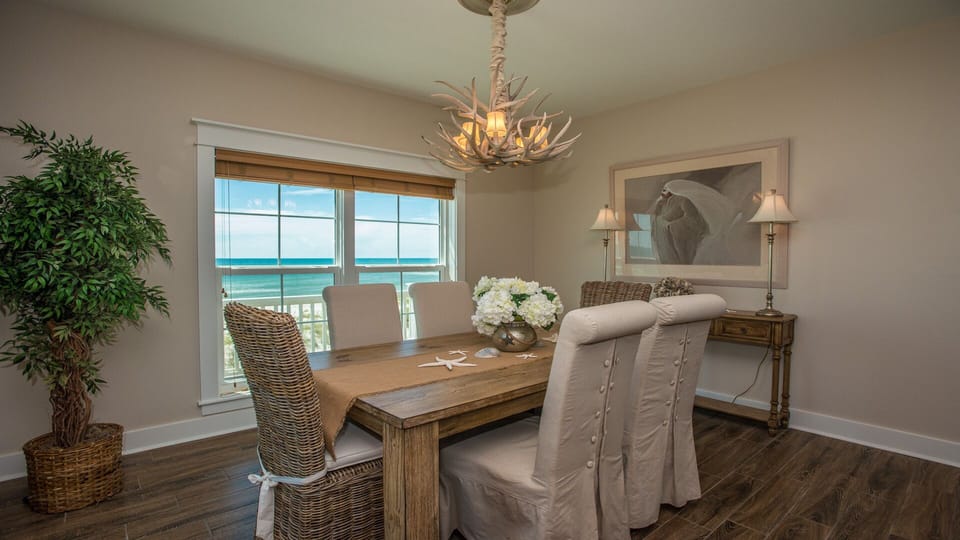 Dining area for 6 with beautiful beach views (another window on left wall).