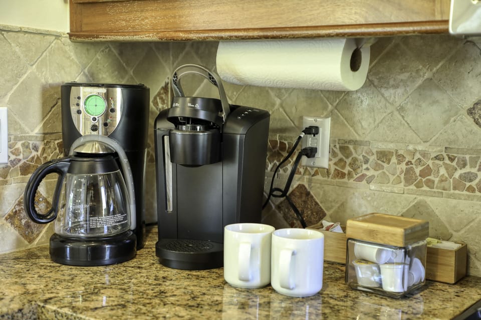 Kitchen furnished with a coffee maker and Keurig. A few coffee pods and sugar included.