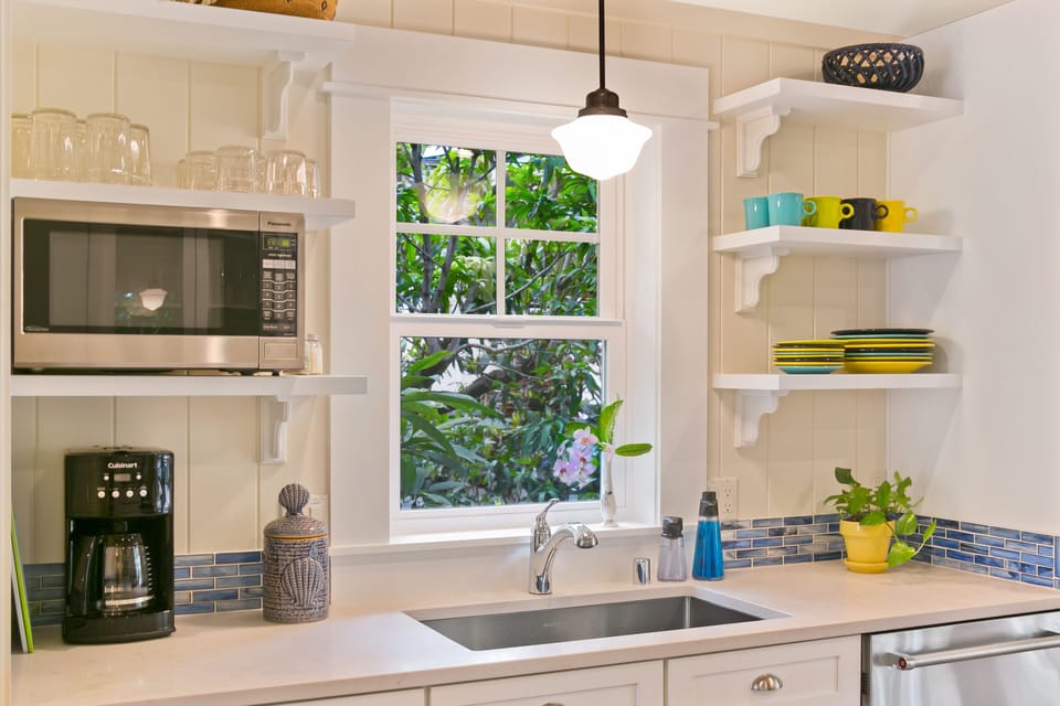 The kitchen window provides a view of plumeria, croton and mango trees.