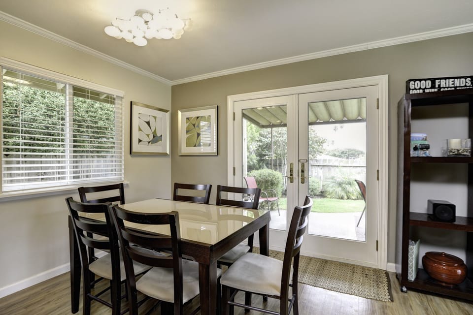 Experience seamless indoor-outdoor living as double doors off the dining room unveil a private, beautifully landscaped backyard oasis.