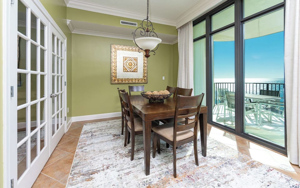 Gather around this inviting dining table, taking in delightful coastal vistas through expansive glass doors