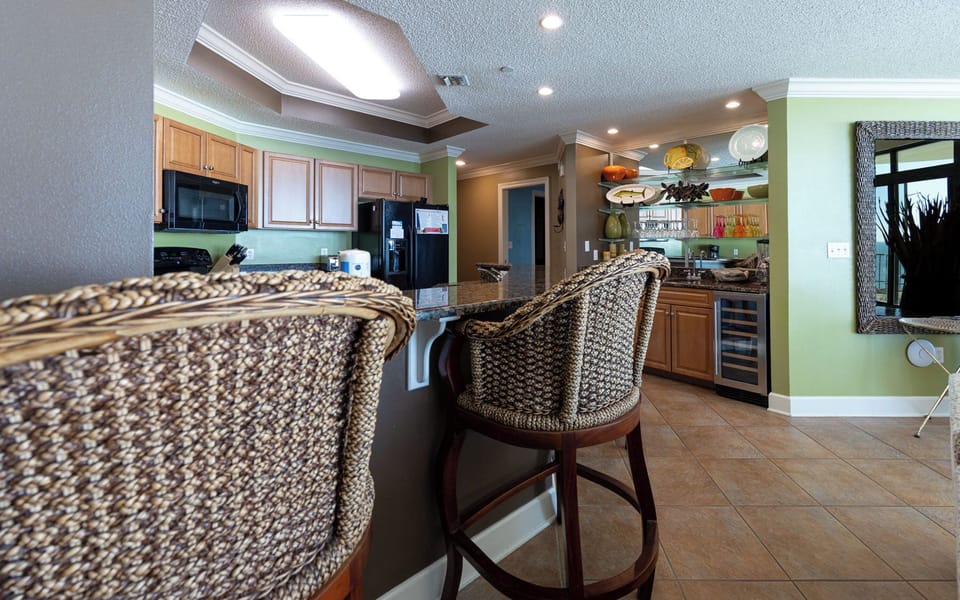 Gather around the inviting bar stools, sipping coffee while enjoying the vibrant decor and a view of the coast