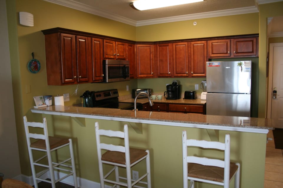 Granite countertops and stainless appliances. Dining room table with bar seating