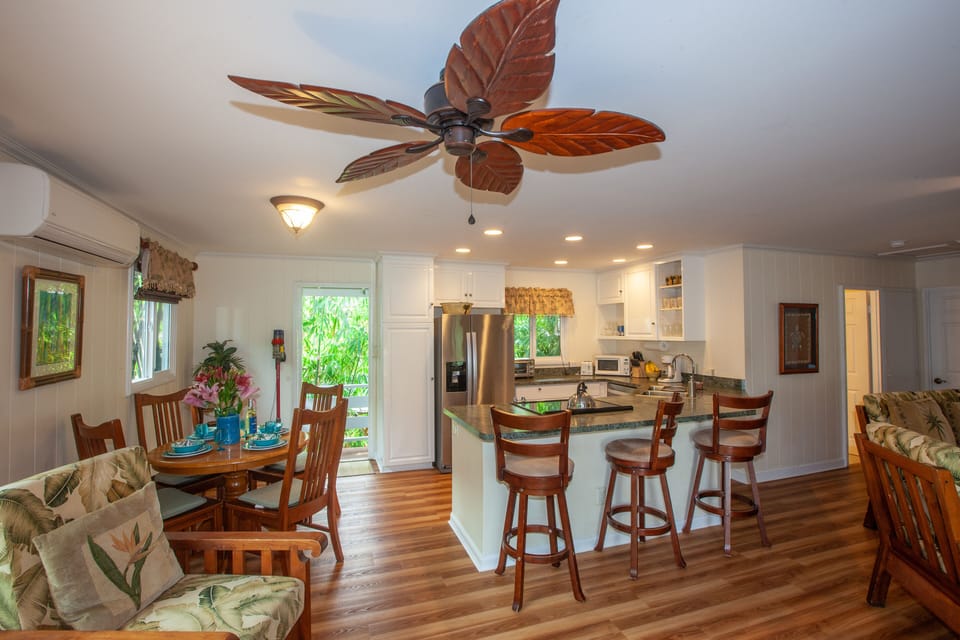 Open floor concept with 4 person dining table and 3 barstools 
