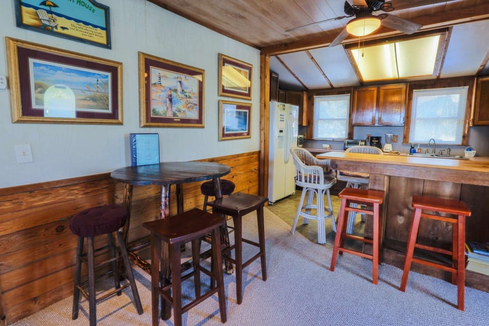 There's also seating for 4 people at a high top dining table near the kitchen.
