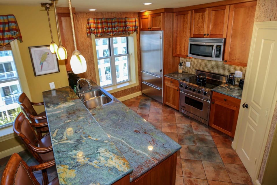 The kitchen features granite countertops, tiled backsplash and cork-lined walls.