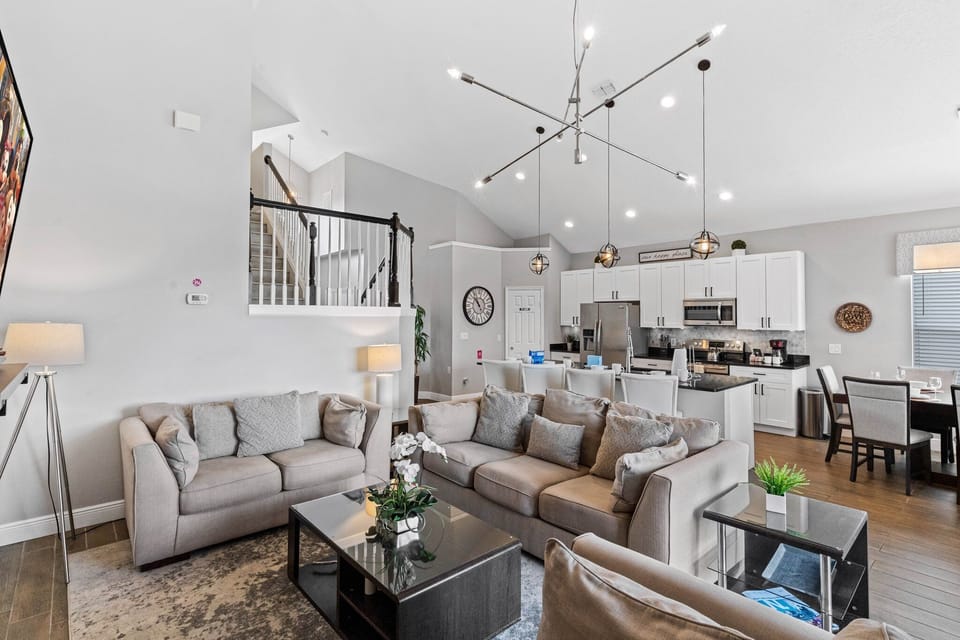 Living room  Modern and spacious living room adorned with elegant furnishings and a large Smart TV, creating the perfect setting for relaxation and entertainment.