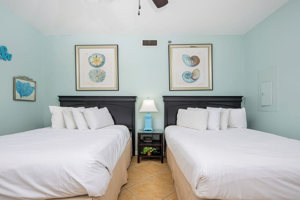 The artwork complements two double beds, creating a refreshing and inviting atmosphere in this guest room