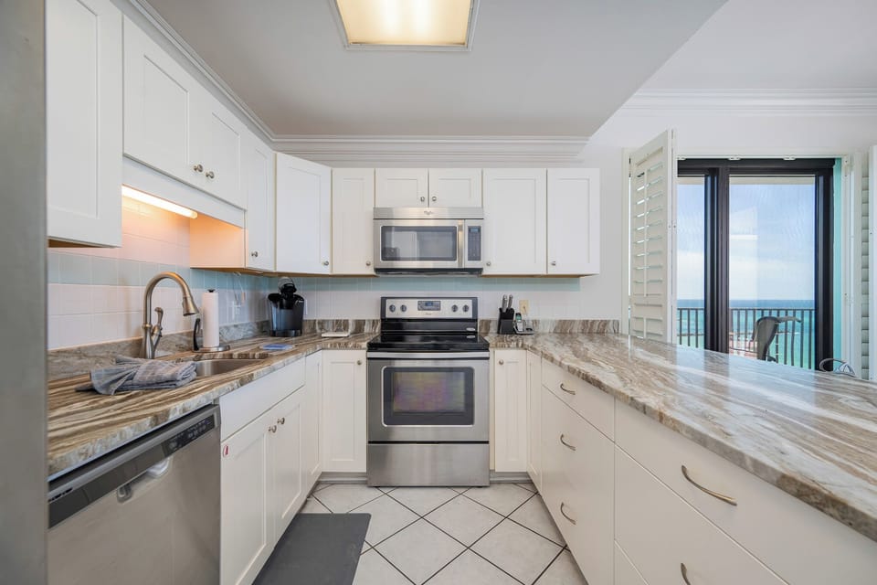 Whip up fresh meals by cool countertops as gulf breezes drift in through open shutters in this kitchen