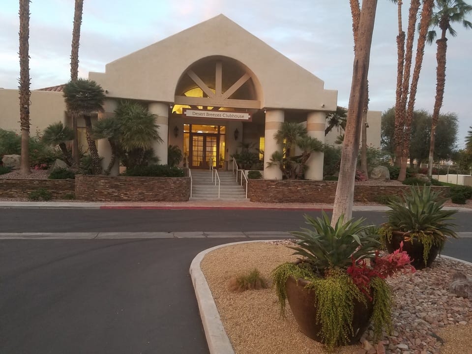 Desert Breezes Clubhouse viewed from security gates at Fred Waring entry