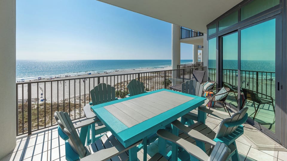 Relax on your balcony and soak in the vibrant coastal views while enjoying time with family around the dining table