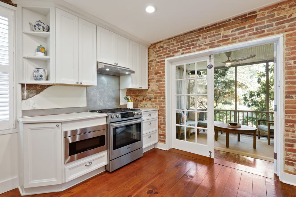 Kitchen looking towards screened porch with overhead projector