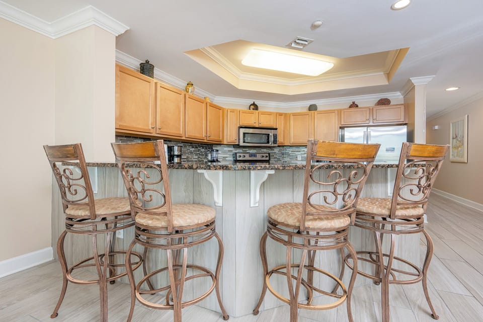 Sip your morning coffee at the bar stools, relishing the beach vibes in this cozy kitchen space