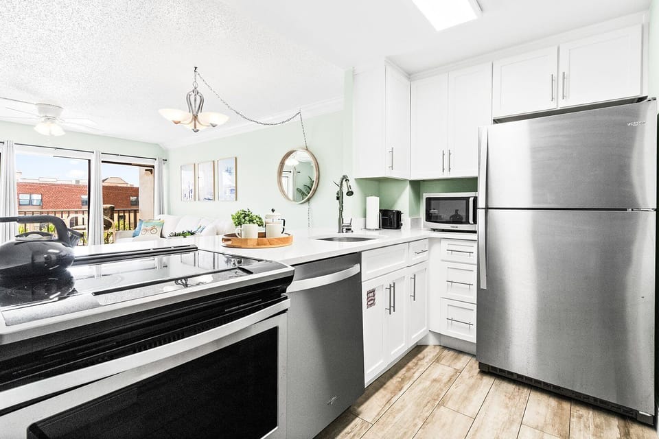 Modern kitchen with stainless steel appliances and elegant finishes.