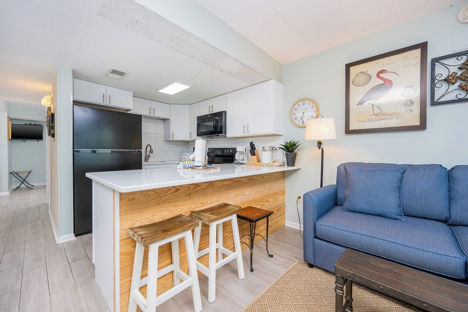 This inviting kitchen features modern appliances and a cozy seating area, perfect for enjoying meals together