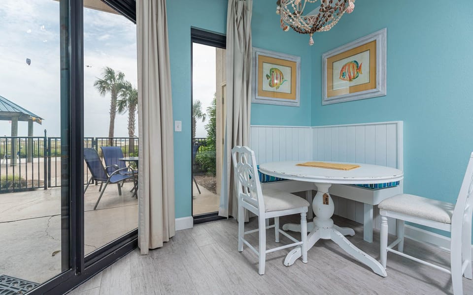 Enjoy meals at the round dining table, with beach views and cheerful decor enhancing your dining experience