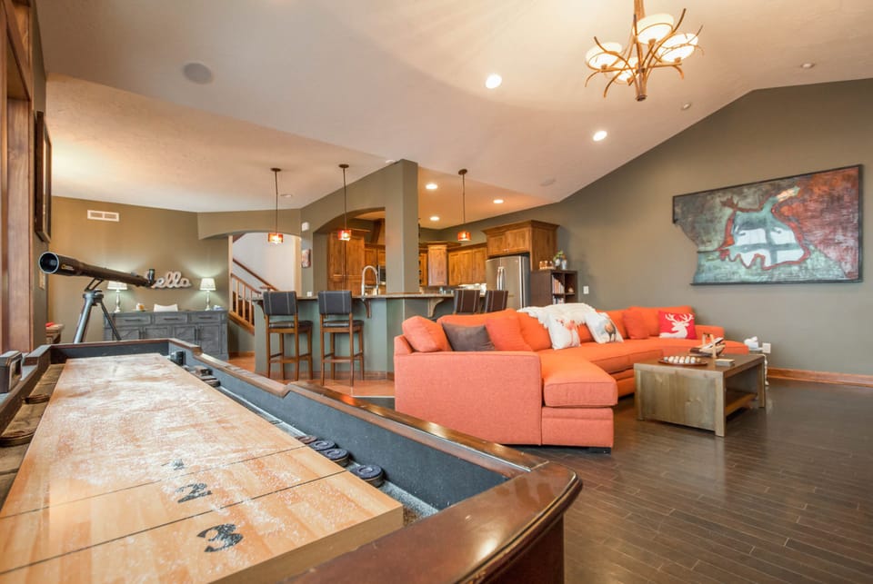 living room with kitchen behind and dining to the left