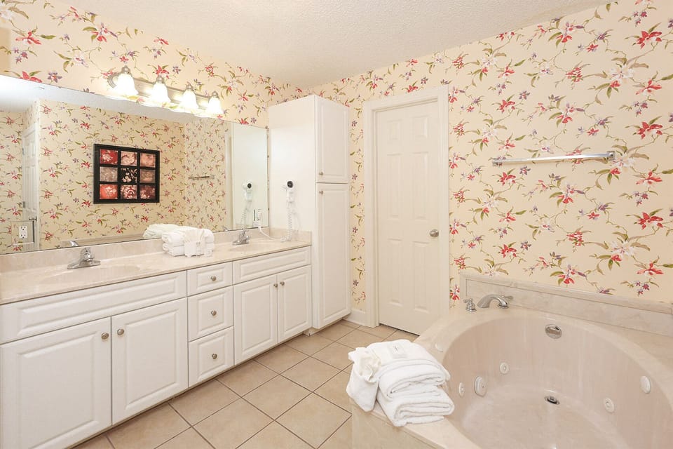 Refresh in the master bath after a day at the beach with a soothing jetted tub and relaxing walk-in shower