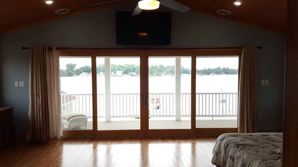 16ft doors, a private balcony, and cathedral ceilings greet you in the master