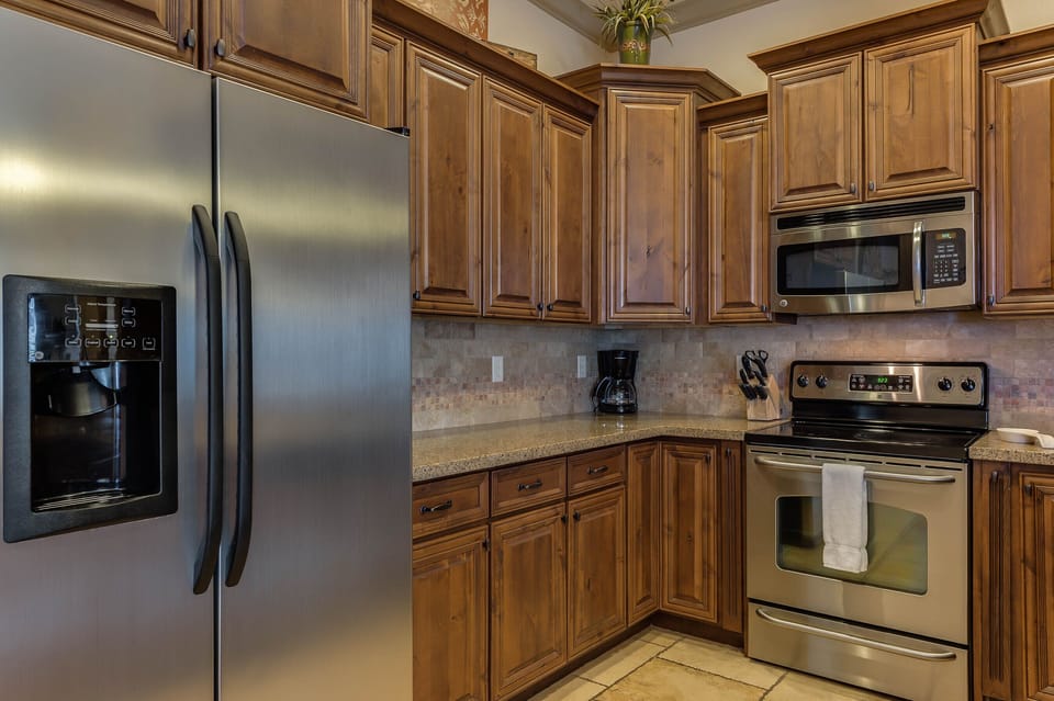 Fully stocked gourmet kitchen featuring stainless steel appliances