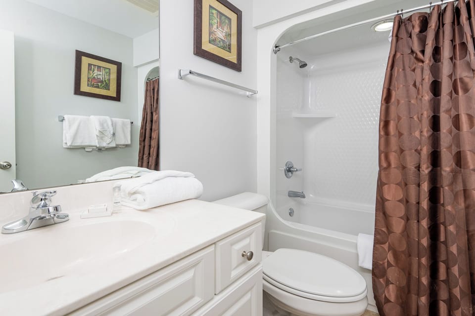 Refresh and rejuvenate in this guest bath, featuring plush towels and a relaxing shower for your beach getaway