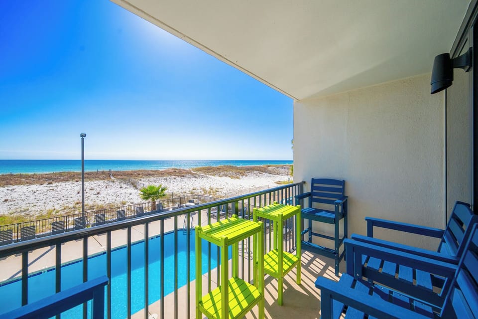Relax on your balcony while taking in the stunning coastal views and the inviting pool below