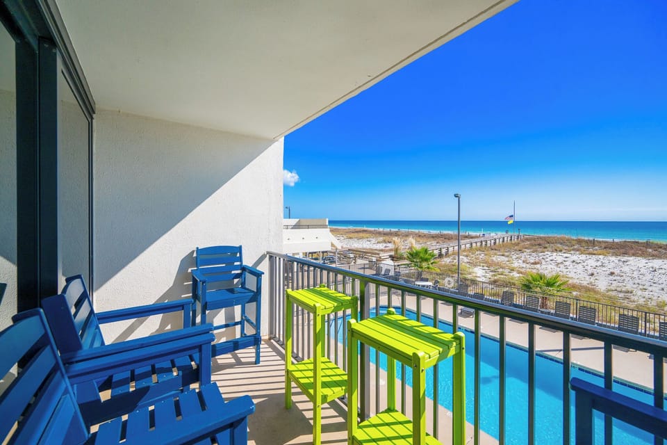 Savor the coastal vibe from your balcony as you enjoy a cool drink and take in the beautiful views of the pool and shore