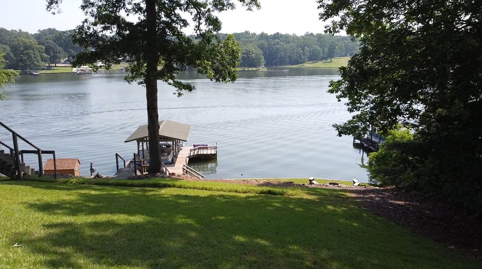 Covered dock with built in bench, swing and swim platform.