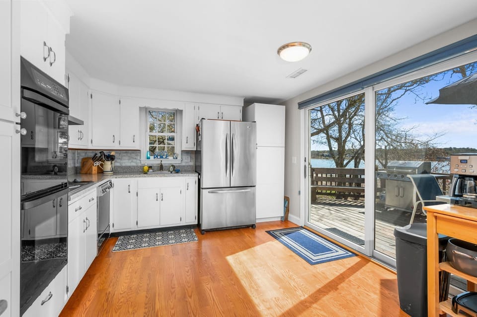 Fully equipped kitchen with sliding glass doors to expansive deck - 84 Cranberry Lane Chatham Cape Cod -  Ridgevale Retreat