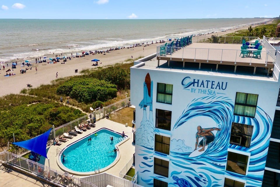 Aerial view of Chateau by the Sea, featuring a beachfront pool