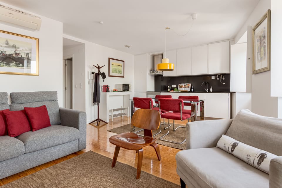 Stylish decor, comfortable couches and a bright living room with an open kitchen