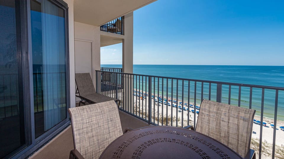 Sip your drink at the outdoor table while enjoying expansive views of the tranquil waters and beach below