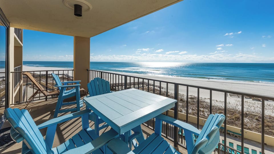 Relax in vibrant seating on your balcony, soaking in stunning coastal views and the gentle sounds of waves