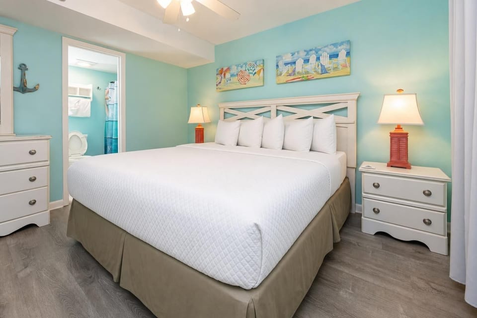 Drift into relaxation on the plush king bed, surrounded by soothing colors and ready for restorative nights on the coast