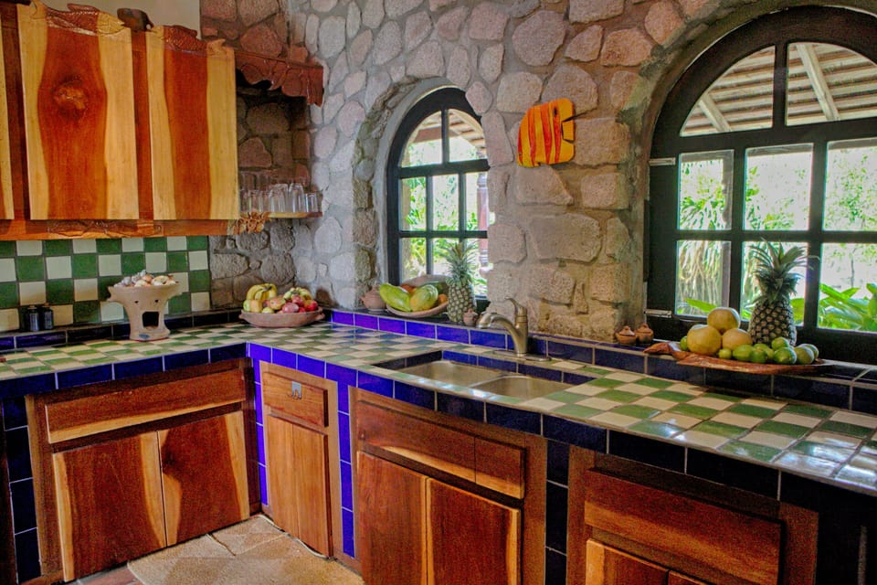 The vibrant kitchen is handmade using local wood and stone and tile.