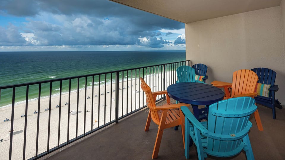 Sip your morning coffee in vibrant chairs while enjoying breathtaking views of the beach and water from the balcony