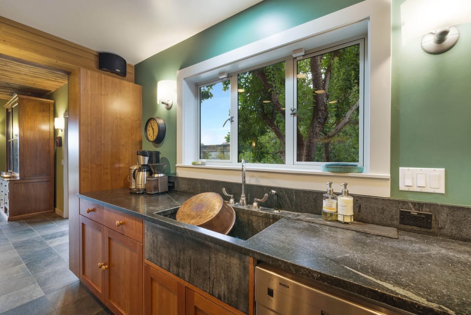 Farmhouse sink with Chicago faucet, soapstone counters on cherry shaker cabinets