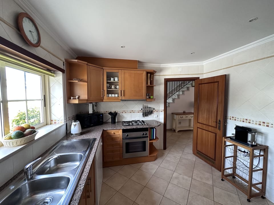 The kitchen with a Nespresso coffee machine which takes original capsules.